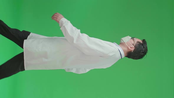 The Side View Of Asian Doctor With Stethoscope Wearing Mask While Walking On Green Screen alt