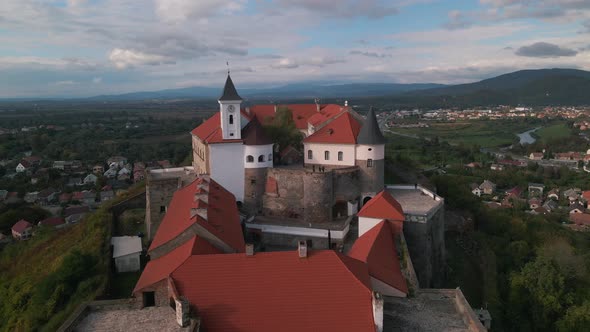 Aerial View of Medieval Castle on Mountain in Small European City at Cloudy Autumn Day alt