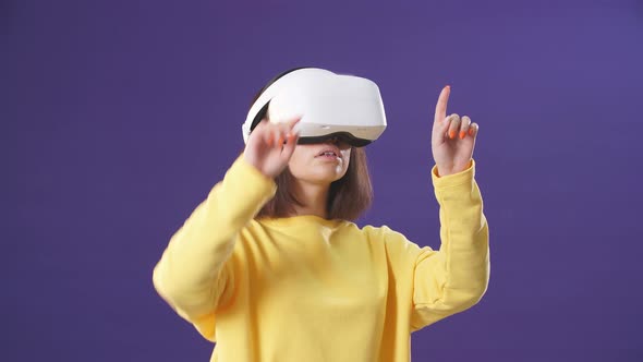 Beautiful Young Woman Playing Game in Virtual Reality Glasses