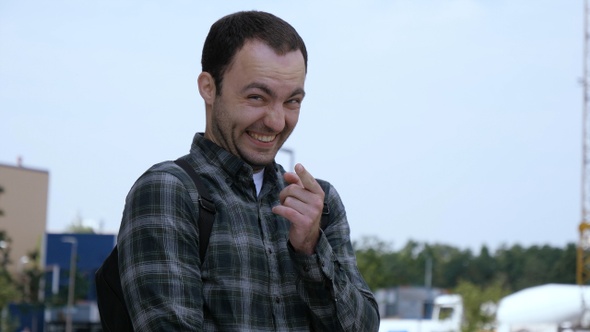 Attractive Millennial Man Laughing out Loud and Pointing alt