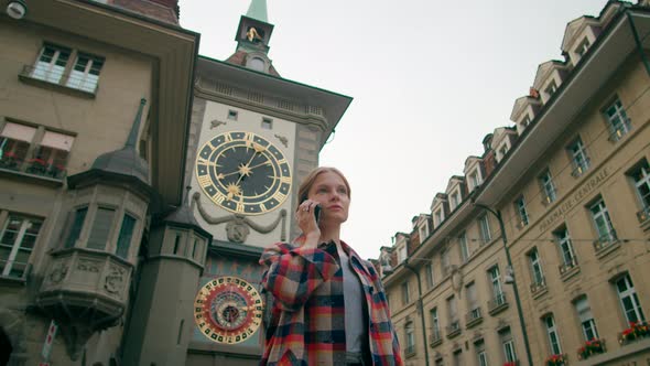 Woman Talks By Phone in Bern Near Landmark Clock Tower Zytglogge Switzerland
