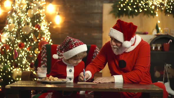 Christmas Helper and Santa, Grandfather Santa and Grandchild Son Writing Wish List Letter To Santa alt