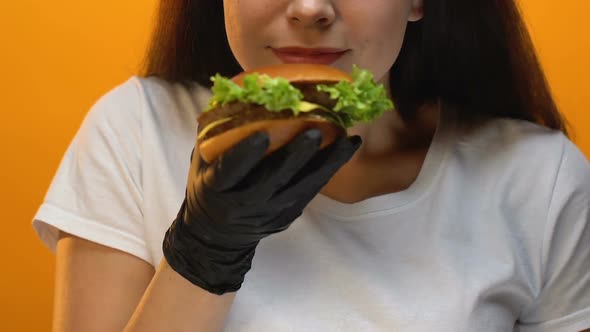 Fast Food Restaurant Client Showing Burger Into Camera, Tasty Unhealthy Food alt