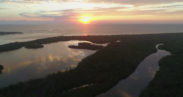 Sunset and Clouds Reflecting on Ocean by Jupiters Island alt