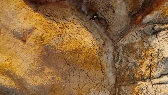 Young man walking inside narrow canyon in the desert Hiker is walking on a narrow trail Ural Mars alt