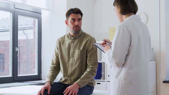 Man Patient Showing Sore Arm to Doctor at Hospital alt