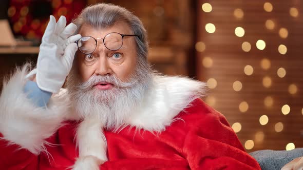 Portrait Surprised Male Santa Claus Looking Through Glasses alt