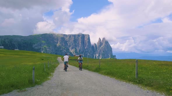 Couple Men and Woman on Vacation in the Dolomites ItalyAlpe Di Siusi  Seiser Alm South Tyrol Italy alt