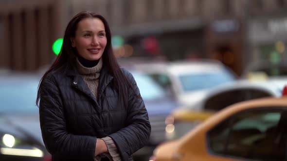 Smiling Woman Outdoors in City, Standing on Parking with Automobiles at Autumn Day, Medium Portrait alt