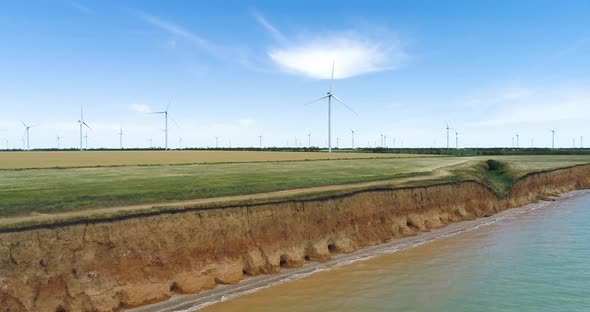 Group of windmills for electric power production on the shore of the sea