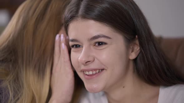 Closeup Curios Young Woman with Surprised Facial Expression Laughing Listening Rumors As Friend alt