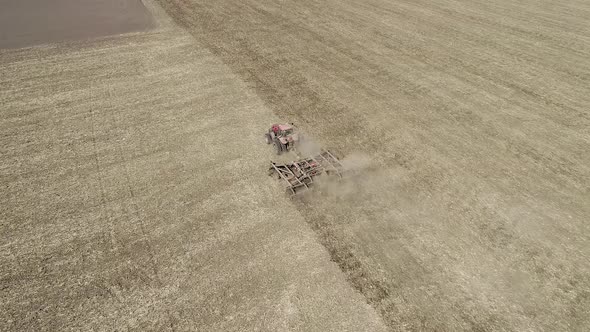 Tractor Processes the Field Before Sowing alt