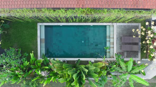 Aerial View From Above of a Beautiful Swimming Pool in a White Villa with Green Tropical Plants Two