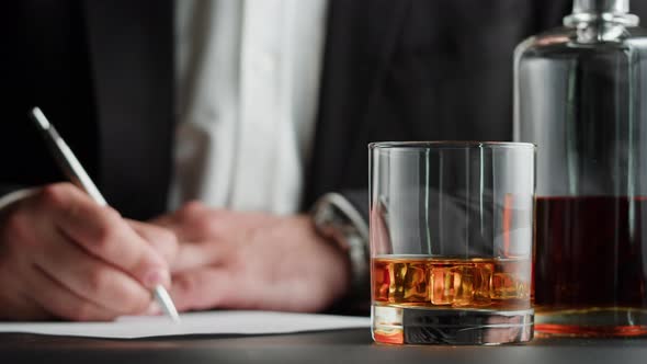 Businessman Drinking Brandy or Whiskey Closeup alt