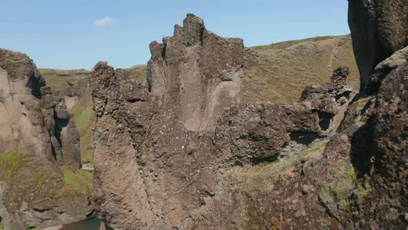 Birds Eye View of Rocky Formation of Fjadrargljufur Canyon in Iceland alt