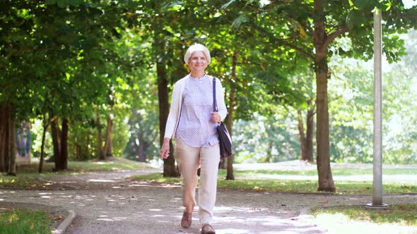 Happy Senior Woman Walking Along Summer Park 2 alt