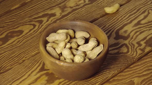 Peanuts fall into wooden cup