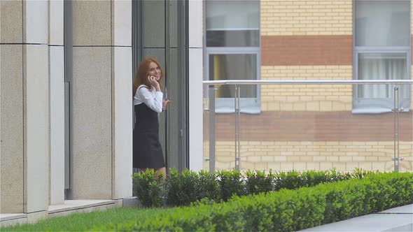 Smiling Business Woman on the Phone at Modern Building, Slow Motion alt
