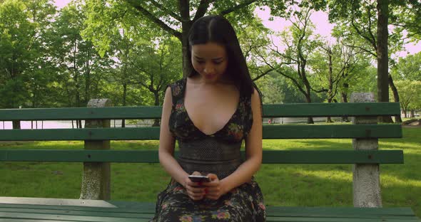Girl Texting On Cell Phone In The Park b