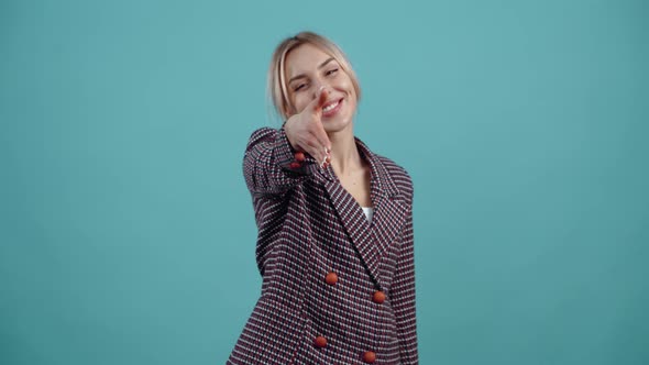 The Friendly Charismatic Young Woman Extends Her Hand and Says Hey in Greeting Displays a Wide Smile alt