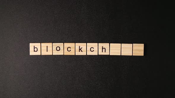 Wooden Cubes Open And Sets Up A Word «Blockchain" alt