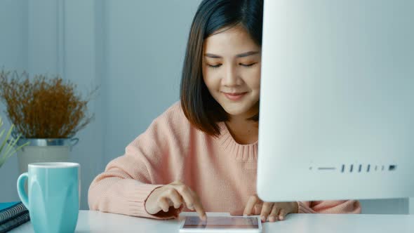 Young Asian women business owners using app smartphones.