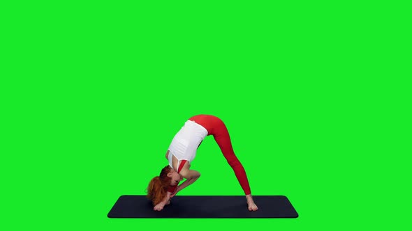 Athletic Fit Woman Stretching On Mat During Yoga Against Green Screen Background