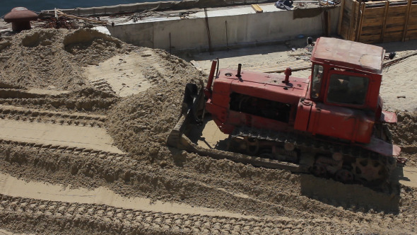 Red Bulldozer at Work in Sea Port