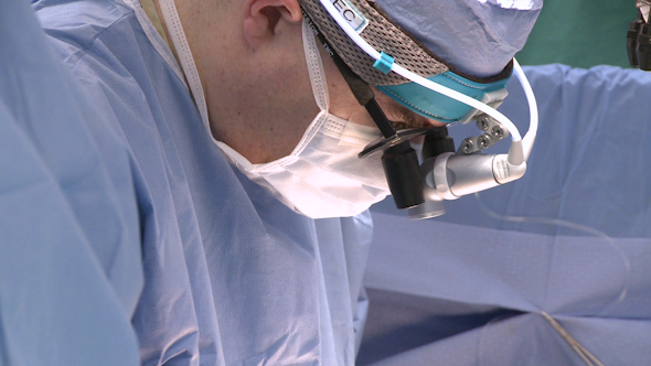 Side View Of Surgeon Focusing On Operation