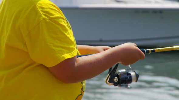 Close-Up Of Boy Fishing Off Pier (1 Of 2)