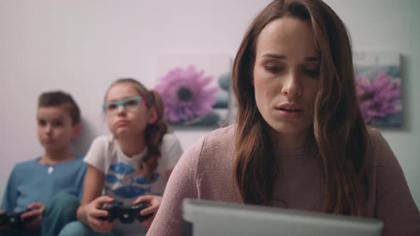 Worried Mother Looking Tablet PC alt