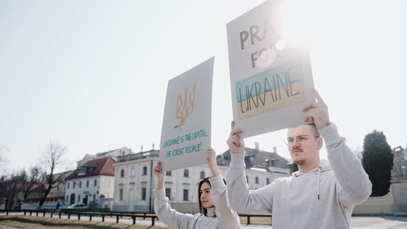 Young People with Raised Posters Calling to Stop the War in Ukraine alt