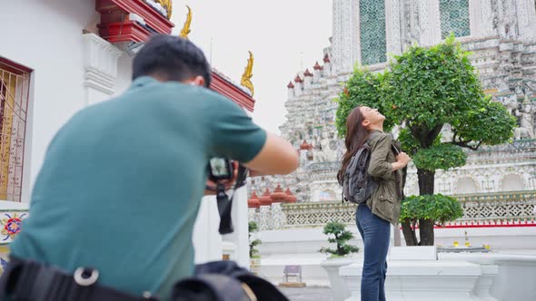 Asian romantic backpacker couple travel in the city for honeymoon trip. alt