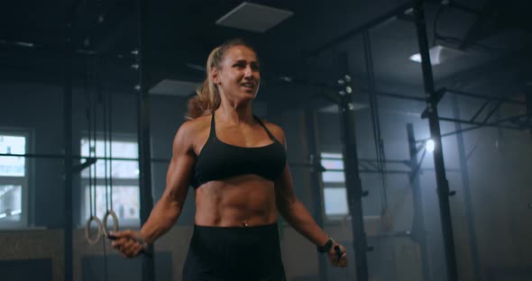 Strong Muscular Young Woman Rope Skipping As Warm Up. Fitness Concept. Young Slim Woman Jumping with alt