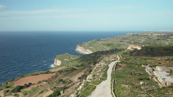 AERIAL: Greeny Landscape in Dingli Cliffs During Winter with Blue Sea and Sky