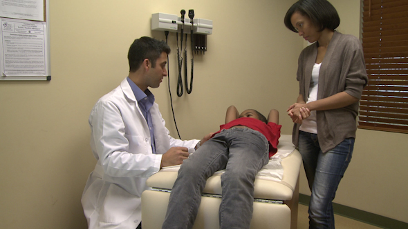 Doctor Checks Young Boy's Abdomen