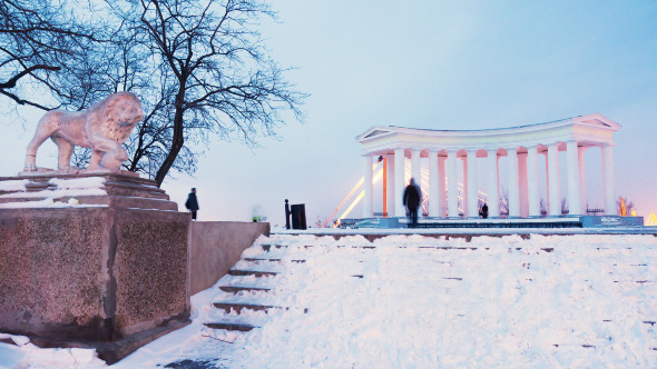 People Walking Near the Colonnade In Winter City