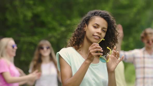Pretty Woman in Sunglasses Dancing With Friends at Summer Camp, Youthfulness alt
