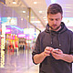 Young Man Walking and Looking at the Phone Young Man Walking and Looking at the Phone - VideoHive Item for Sale