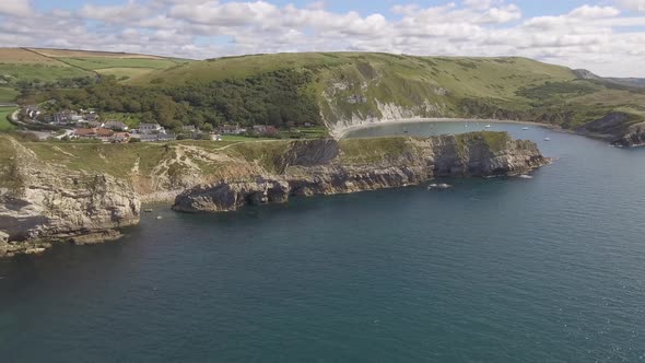 Cornwall aerial drone view of seaside rocky cliffs and turquoise water