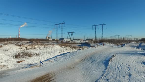 a motorcyclist performs stunts on a winter track alt