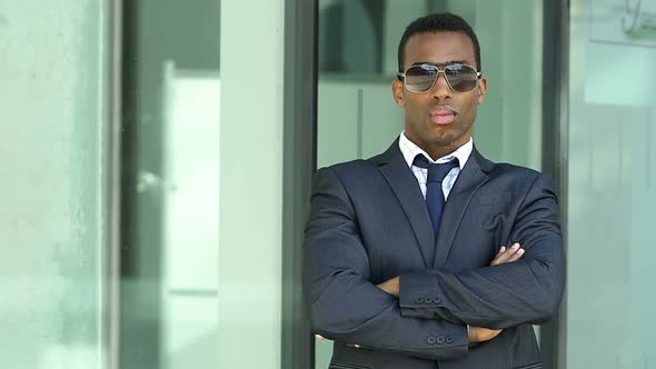 serious african businessman crossing his arms-Success, Business, Leadership - slow motion alt