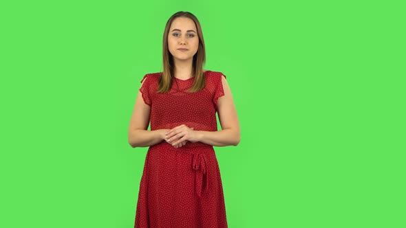 Tender Girl in Red Dress Is Reporting and Telling a Lot of Interesting Information. Green Screen alt