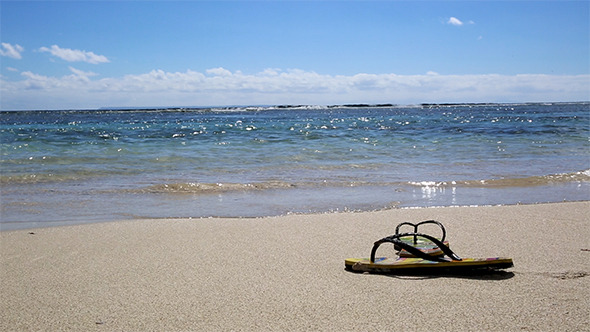 Sandals On The Sand Of The Beach During The Summer