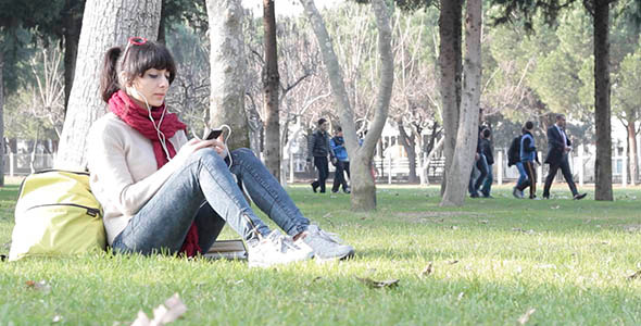 Girl Listening to Music in the Park