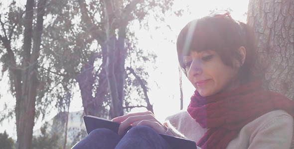 Girl Reading Book in the Park