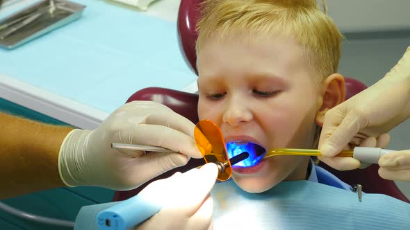 Health Concept. Boy at Dental Clinic Gets Dental Treatment To Fill a Cavity in Tooth. Dental alt