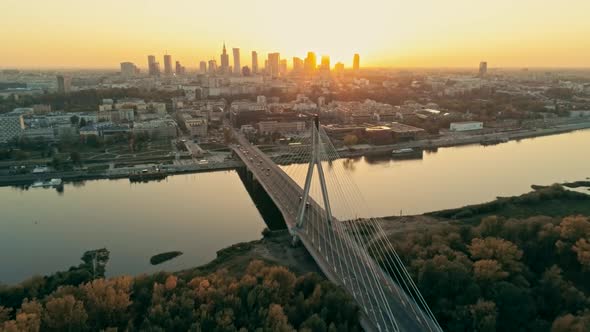 Establishing Aerial Shot of Warsaw Cityscape with Bridge and Downtown at Sunset