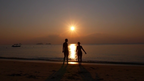 Happy Cheerful Couple Enjoying Sunset At Beach