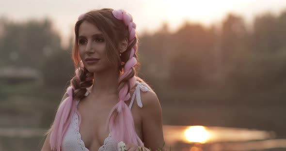 Woman in White Dress Smelling Beautiful Bouquet of Flowers